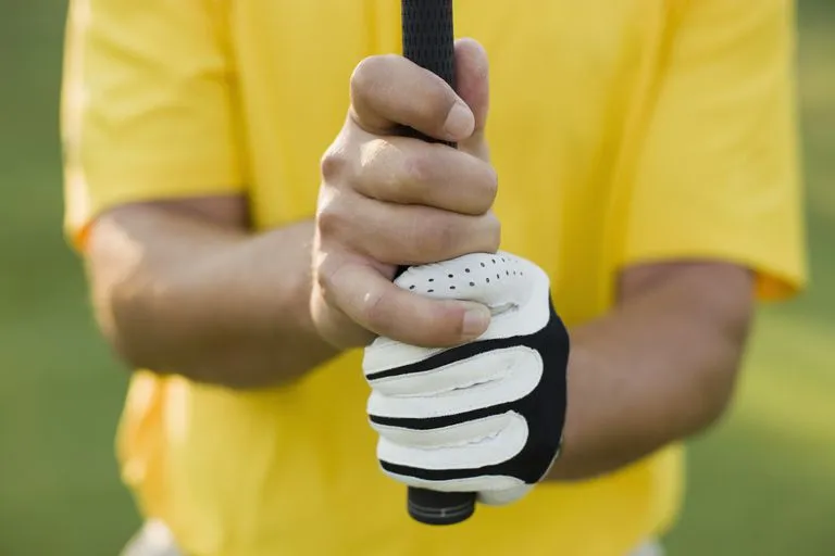  A man with a overlap or Vardon grip holding a golf club